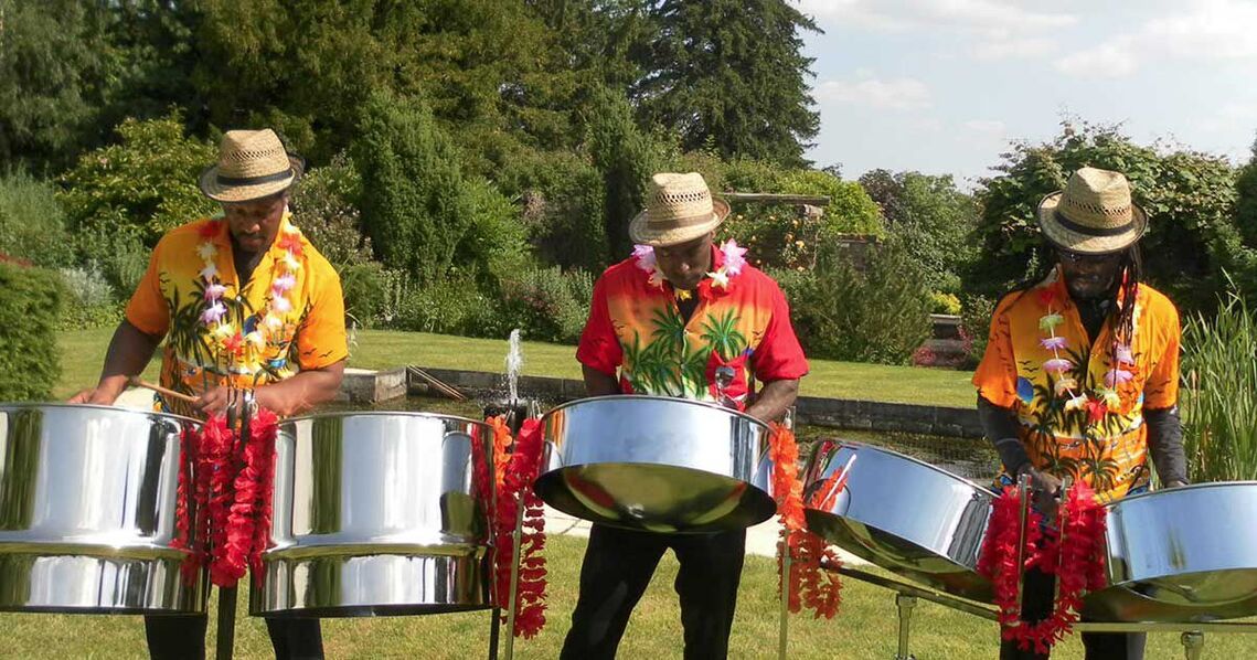 picture steel drum and three caribean players